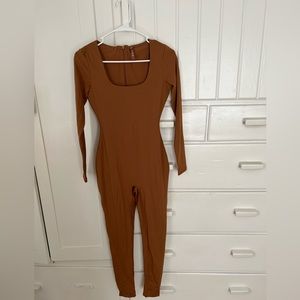 Skims all-in-one scoop neck long sleeved onesie in Carmel